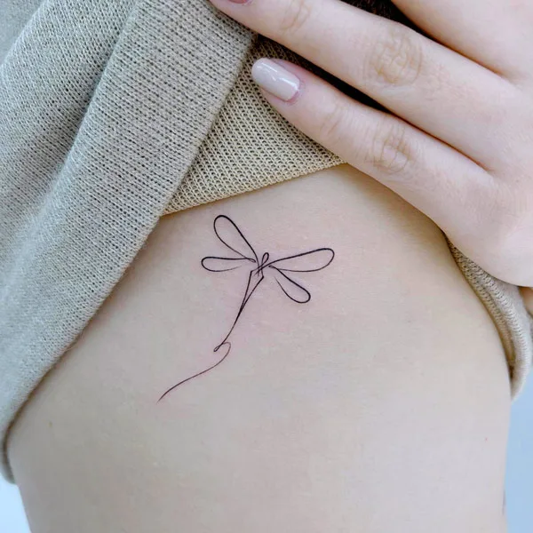 Abstract dragonfly tattoo