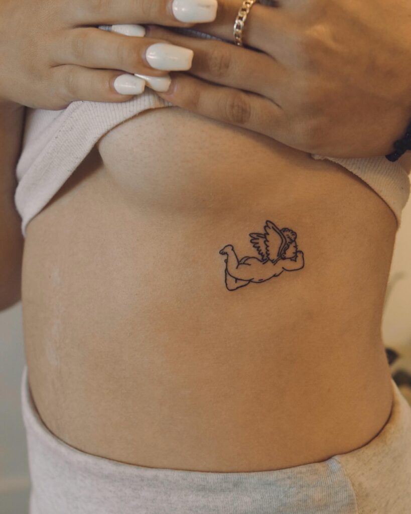 Adorable Baby Angel Tattoo on the Rib in Side View: Tiny Guardian 
