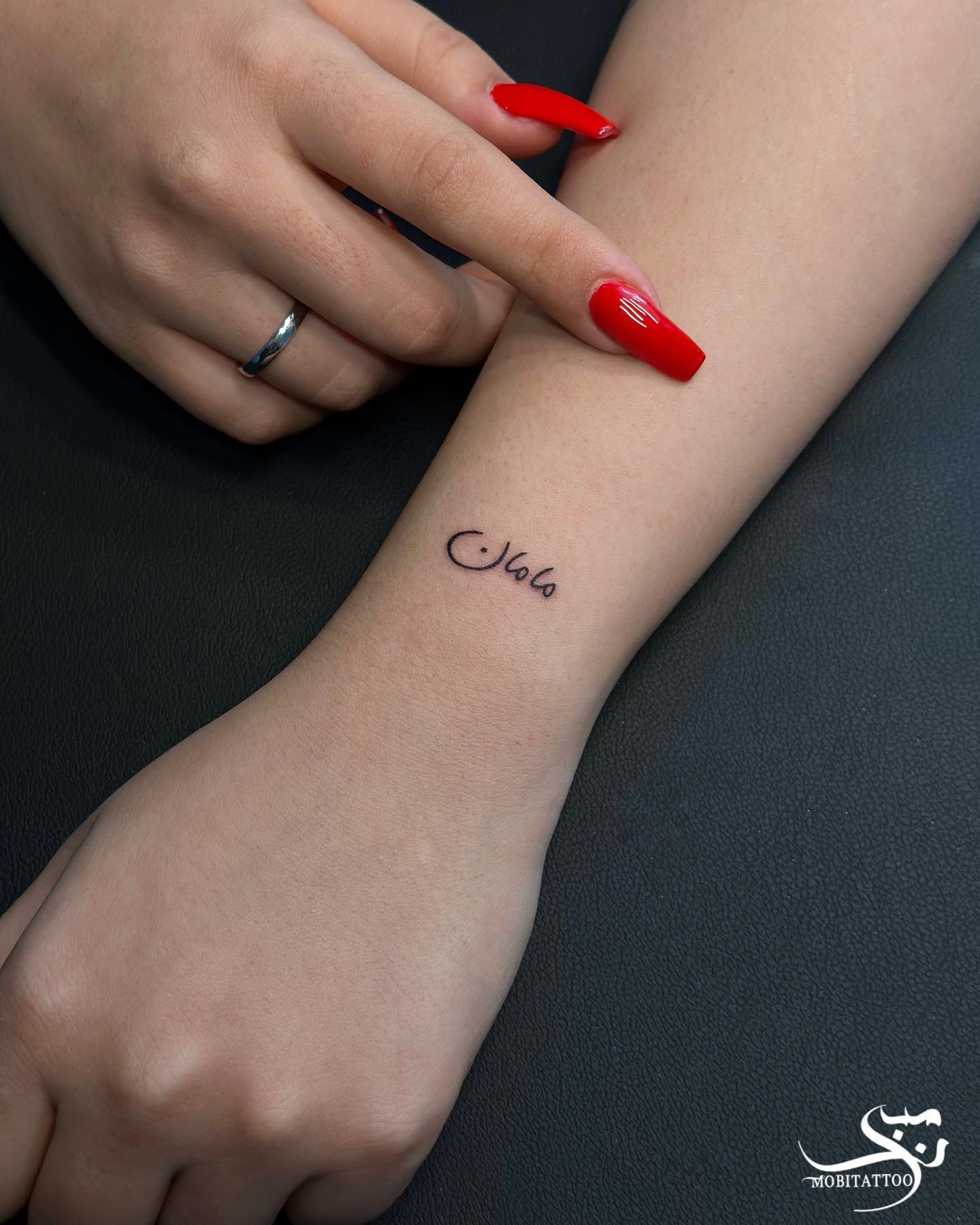 Arabic Mama Script Wrist Tattoo Elegant and Emotional Tribute to Mother 