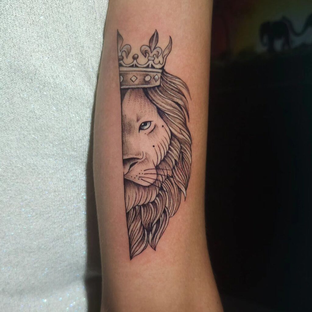 Back of the arm above the elbow, half face lion with crow tattoo: crowning glory 