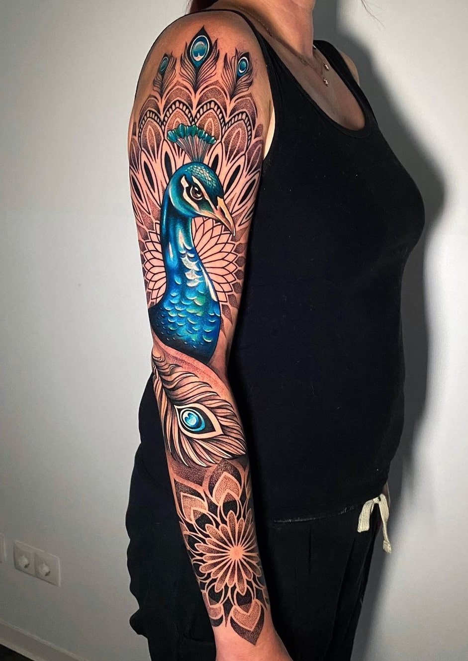 Blue peacock feather tattoo for hand with mandala art