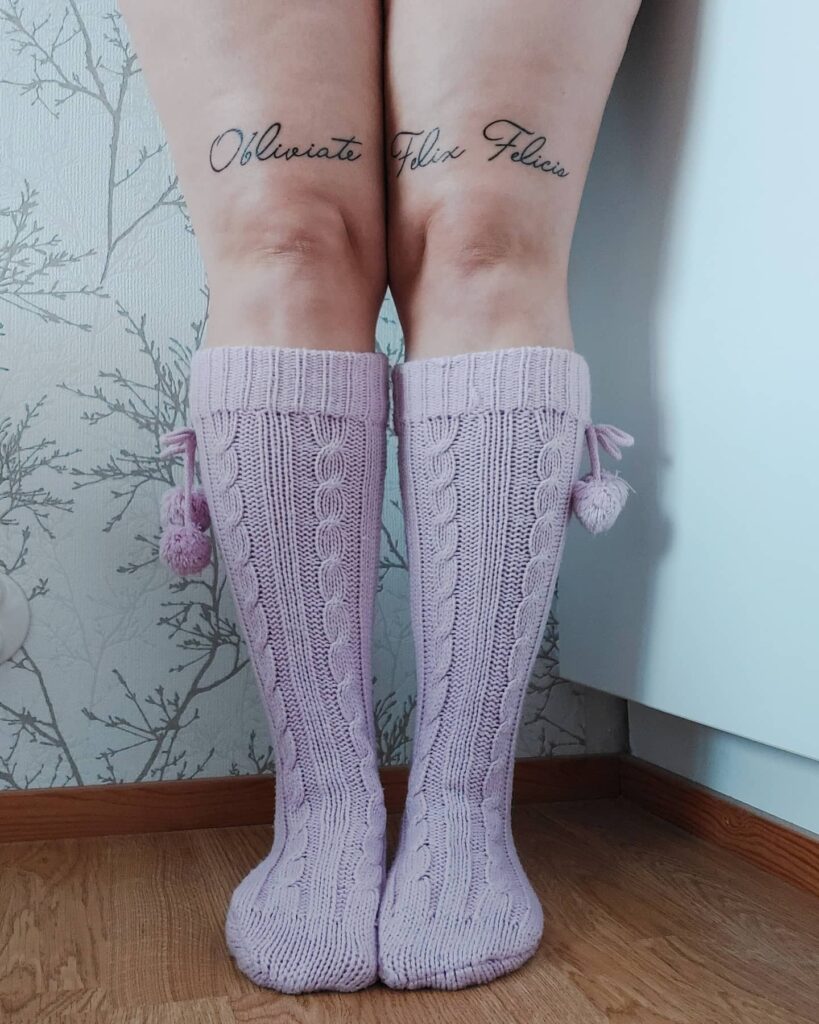 Embracing split personality ink oblivious felix felicis text tattoo above the knee 