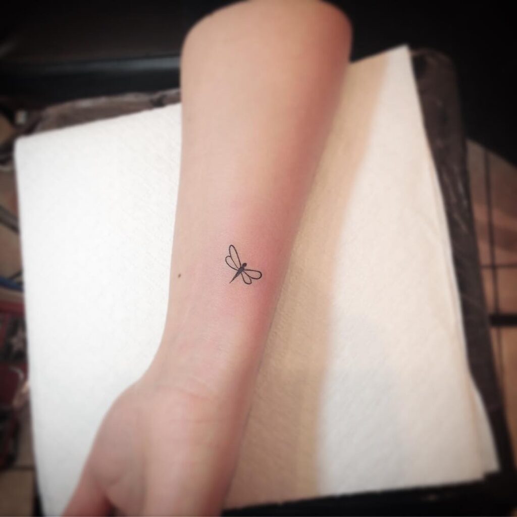 Fine Line Dragonfly Tattoo on Wrist Small and Subtle Tattoo Idea 