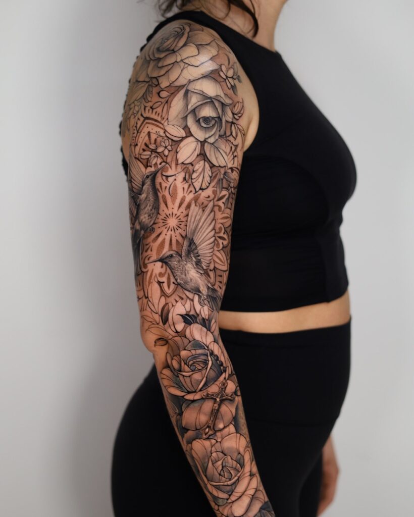 Floral and wildlife tattoo sleeve with mandala and pocket watch details 