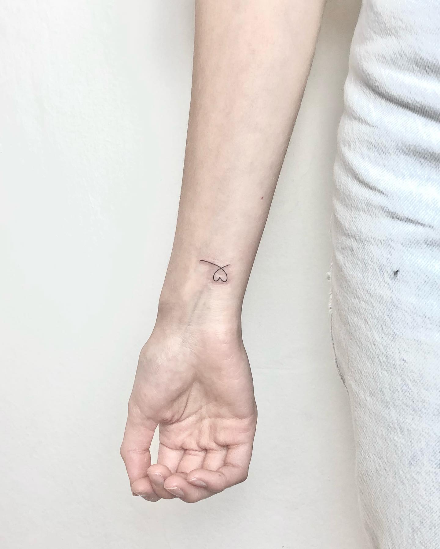 Flowing Line with Heart Minimalist Inner Wrist Tattoo Delicate and Graceful 