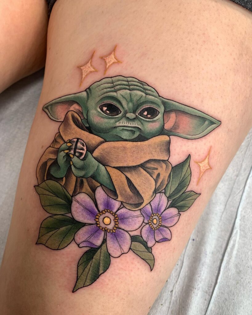 Galactic guardian grogu tattoo with celestial elements above the knee 