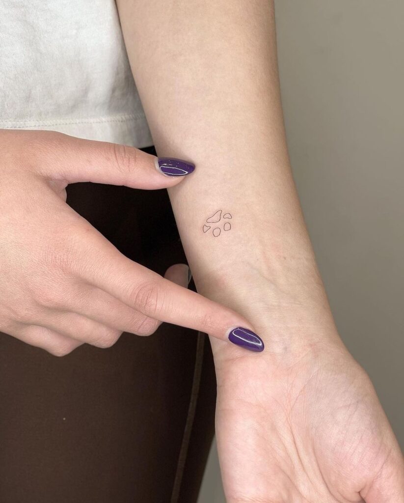 Little Outline Dog Paw Print on Inner Forearm Tattoo: Subtle Statement