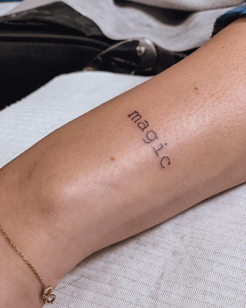 Minimal and stunning magic lettering outer wrist tattoo for females 