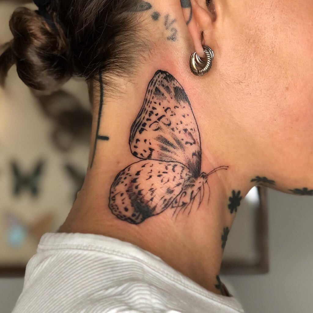 Outstanding freedom in black ink large butterfly tattoo free to fly on the side neck and below the ear 