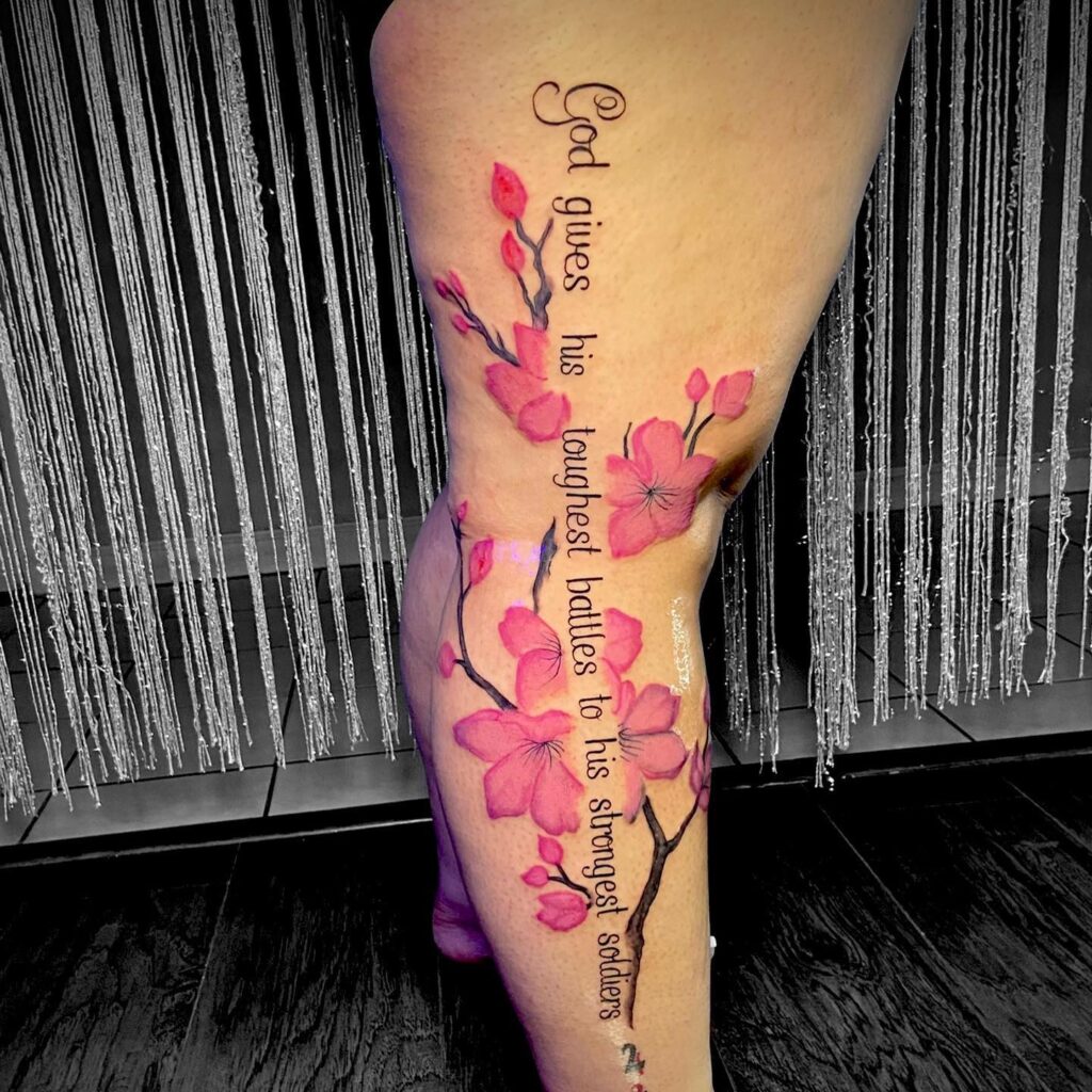 Pink flowers with quote leg tattoo design for women  