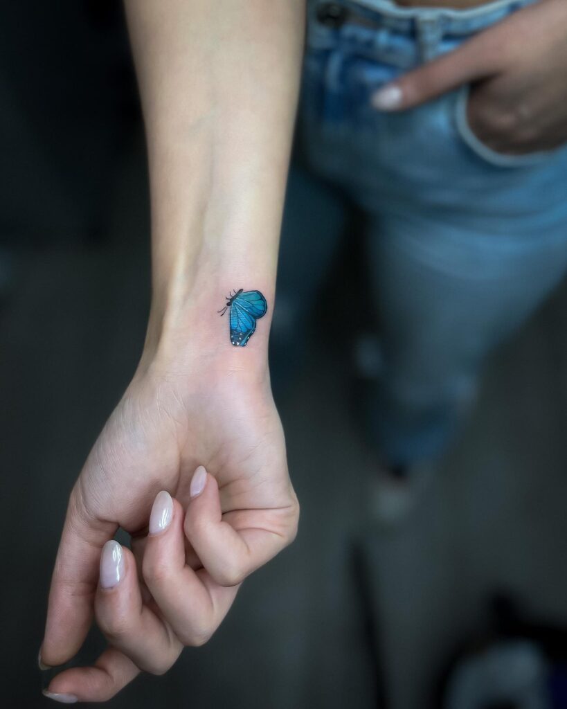 Realistic beauty small blue butterfly tattoo on wrist for women 