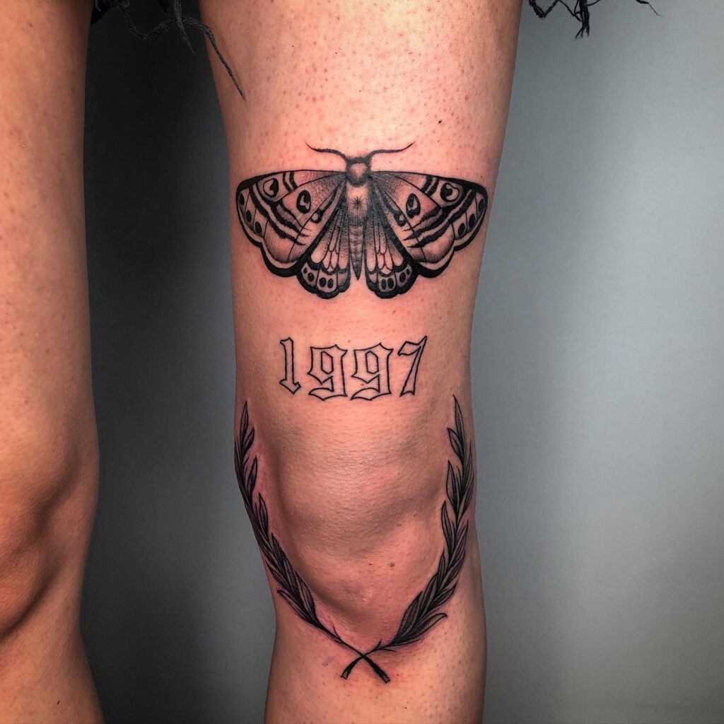 Sentimental ink nature butterfly tattoo with 1997 text on thigh 