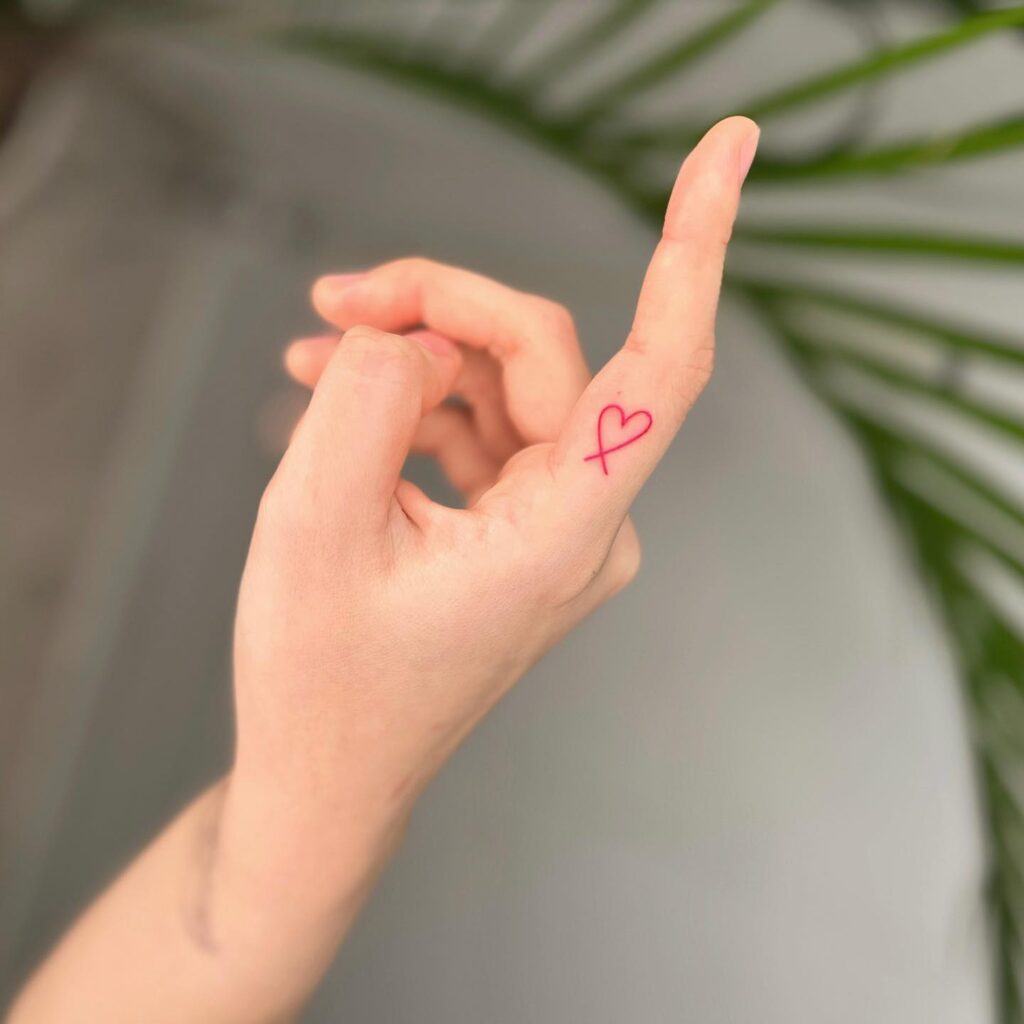 Side of finger love red heart outline tattoo 