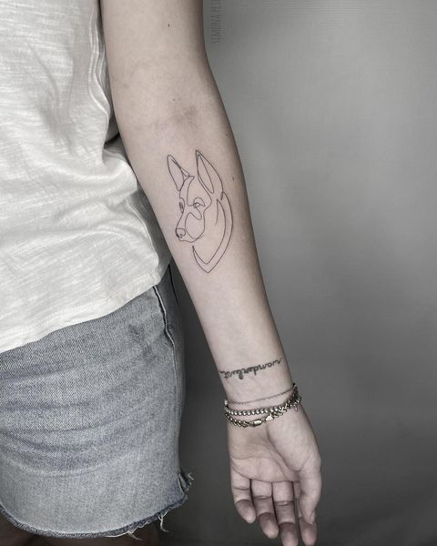 Simple lined german shepherd tattoo design with meaning