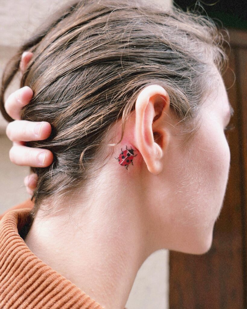 Small Ladybug Tattoo Behind Ear Delicate and Chic Design 