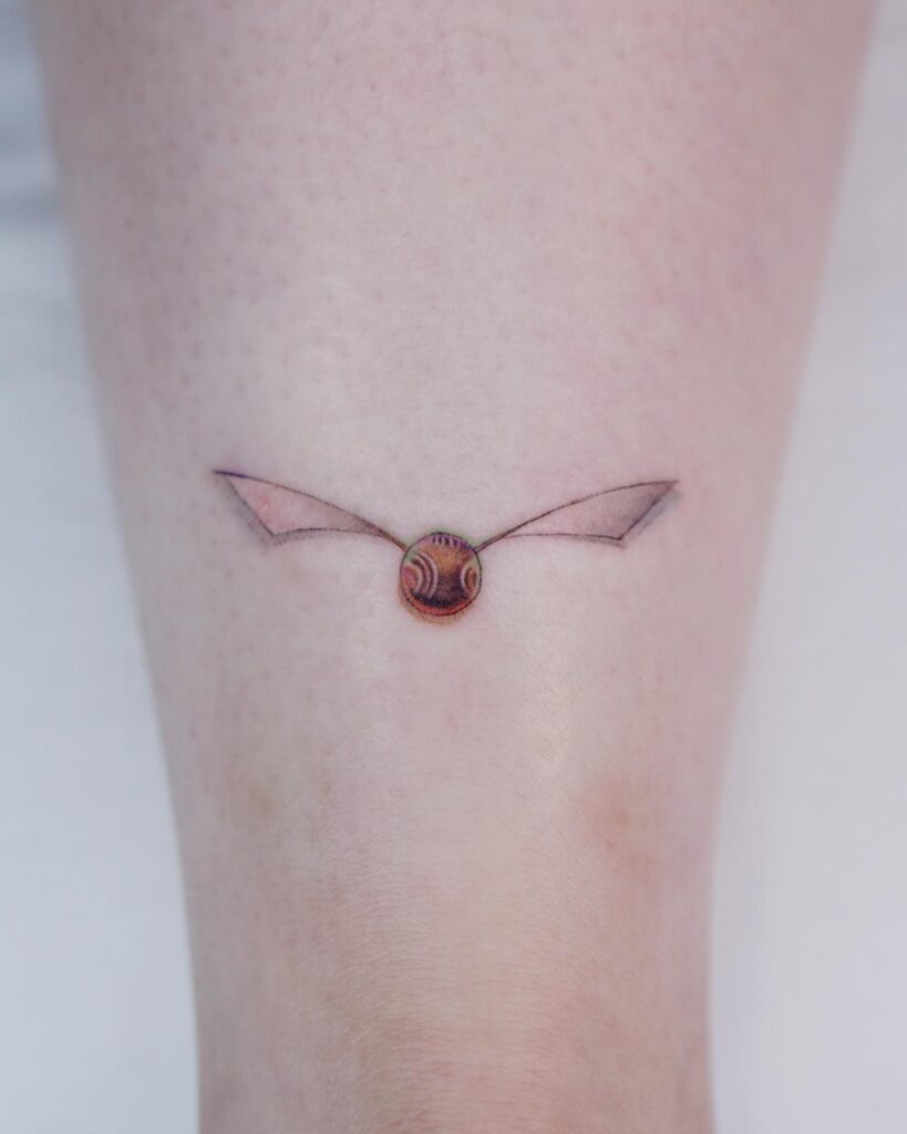 Small and magical harry potter golden snitch tattoo on the calf 