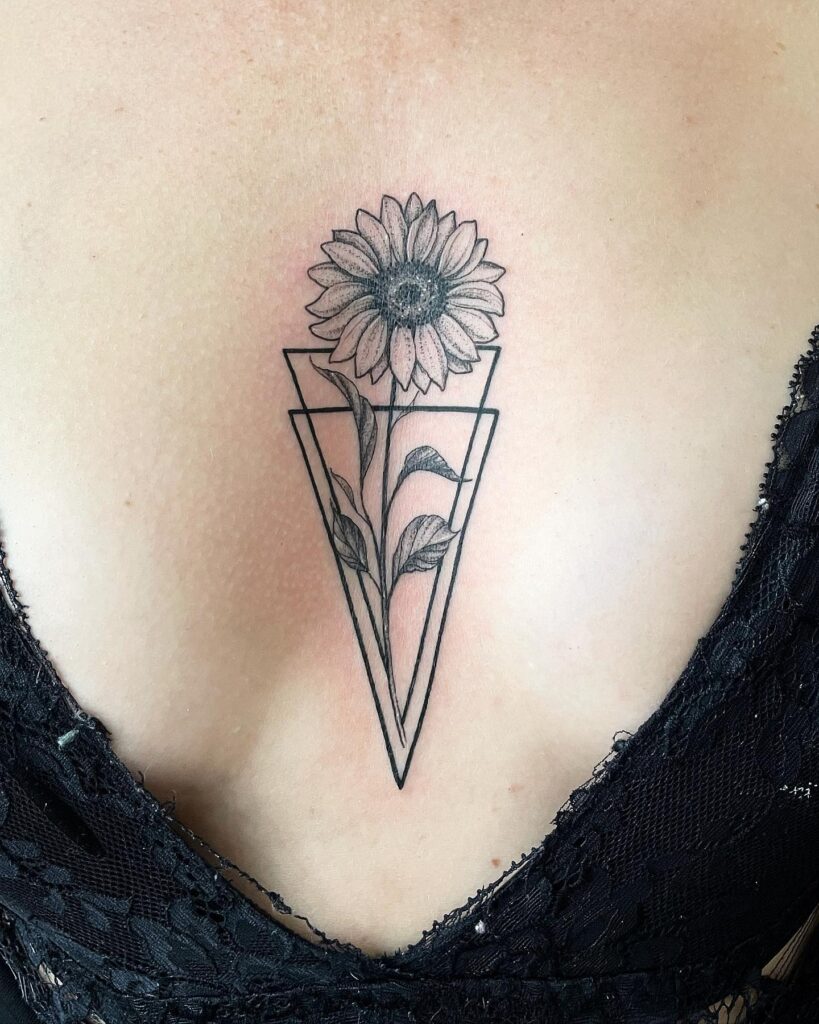 Sunflower sternum tattoo with geometric frame design 