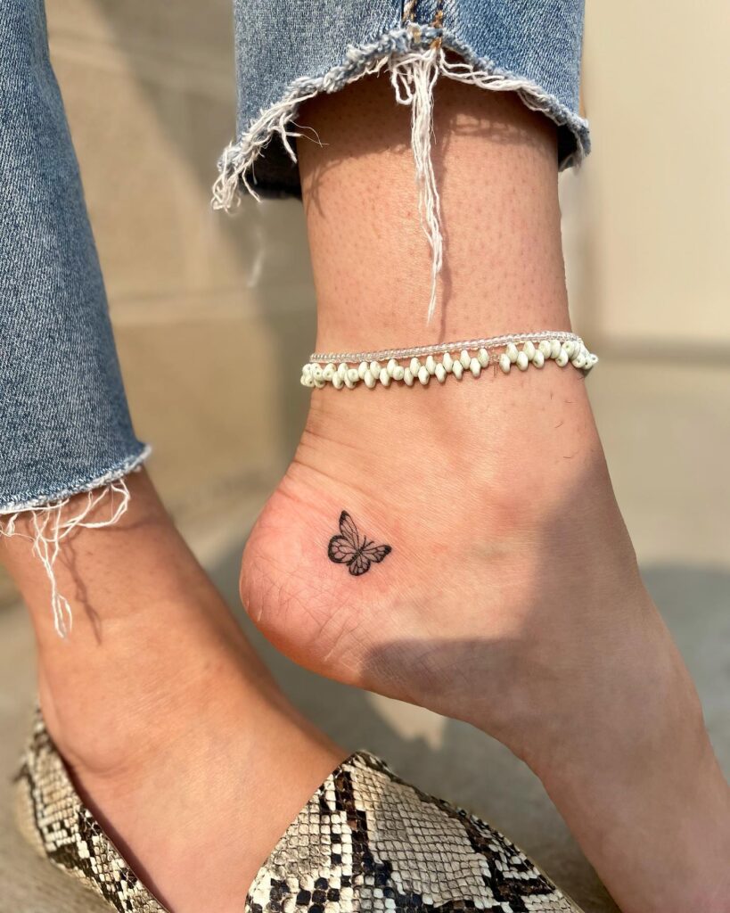 Tiny butterfly below ankle delicate and feminine tattoo idea 